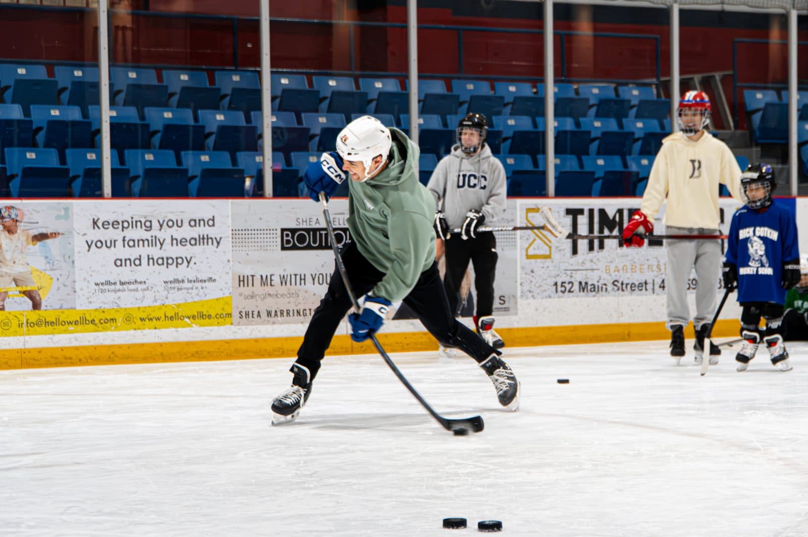 A coach demonstrates a shot during a drill